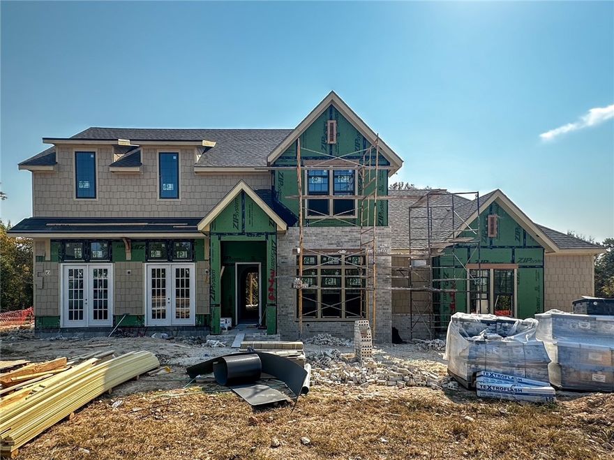 Welcome to this stunning new home by Lane Crosno Designs in Fayetteville’s peaceful Blackberry Ridge community. The entry opens to a guest bedroom/office and a spacious living room with vaulted ceilings, a gas fireplace, and French doors leading to the front porch. Continue through the arched openings to a hall with a two-story ceiling that flows into the open dining and kitchen area. The kitchen features a large island, quartz countertops, Café appliances, and a butler's pantry with a mini fridge, prep sink, and powder bath. Step outside to the back porch, overlooking a wooded backyard with a gas line and CAT6 hookup. Engineered hardwood floors run throughout the main areas, including the downstairs bedrooms. The owner’s suite boasts a vaulted ceiling, walk-in closet, and a spa-like bath with dual vanities, a makeup vanity, walk-in shower, freestanding tub, and private water closet. Upstairs, you'll find a bonus area, three bedrooms, and two baths. The three-car garage is prewired for an EV charger. *Agent Owned*