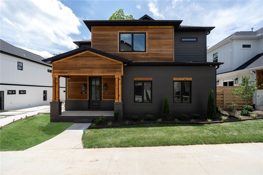 Another stunning Oz Village home with a phenomenal floor plan! This is the ideal downtown Bentonville living neighborhood. Just a few minutes by bike or foot to the square, trails, Crystal Bridges Museum, Compton Gardens, restaurants, shopping and entertainment. This gorgeous, low-maintenance property, allows you to enjoy every moment to the fullest!!! Primary suite is on the main floor with gorgeous ensuite. Plus half bath for guests. Wander upstairs to find 3 additional bedrooms and 2 luxurious baths, and a roomy landing area perfect for whatever kind of flex space you might need! The community has "front porch living" in addition to the community greenspace and guest parking for the village. Welcome home!