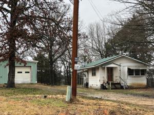 Country setting for this mobile with add on & 25 x 30 garage/shop building with water & electric & 30 x 50 Delta building with a 12 H x 16 W overhead door. Mobile has had some remodeling but still needs TLC. Good location near Branson & Bull Shoals Lake. Special Assessments of $35 & $18. Work will need to be done to have a functioning septic system.