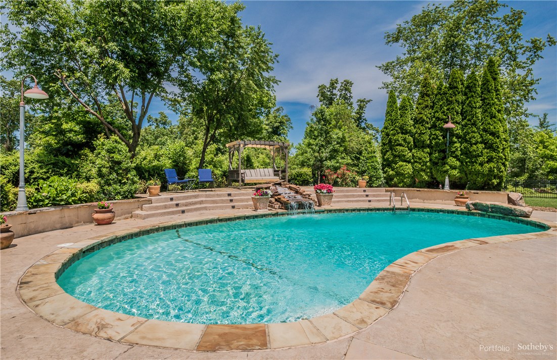 Everything you could want tucked away on quiet cul-de-sac in gated Pinnacle Country Club. Enjoy the outdoor paradise ideal for entertaining w/sparkling heated gunite pool, rock waterfall feature, outdoor kitchen plus firepit overlooking private lush grounds. This European inspired stunner offers a combination of warmth & sophistication. Inviting entry flanked by formal dining, handsome study & guest bath. Gracious gourmet kitchen w/ SS appliances, center island & granite counters offering abundant bar seating. Open to living area & additional dining w/wine chiller & ice maker. Unwind in master suite w/luxurious bath & generous closet w/access to laundry. Upper level features impressive built-ins, 3 guest rooms & fabulous bonus/media room w/kitchenette & half bath. Additional amenities: walnut wood flooring, butler's pantry, walk in closets, central vac, Sonos audio system, Irrigation w/wifi controller, commercial grade hot water tank w/recirculating hot water and new HVAC units.