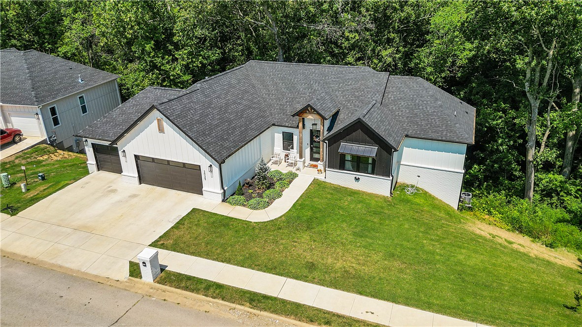 Want to live on the golf course? Hereās your chance! This beautiful two-story home in Big Sugar Golf Course is near the clubhouse, driving range, and Big Sugar gravel trail. Just minutes from downtown Rogers and Bentonville as well as Bella Vistaās trail system. The primary and guest bedrooms are upstairs, while additional bedrooms sit in a spacious walkout basement with its own living area. A partially unfinished sectionāalready counted in the square footageācould serve as a media room, gym, office or more. Only a couple years old, the home features updated systems, a solid roof, granite countertops, and luxury vinyl plank flooring throughout. Enjoy entertaining in the open floor plan, outdoor living on double decks, and ample storage in the three-car garage. So much to see. Book your private showing today!