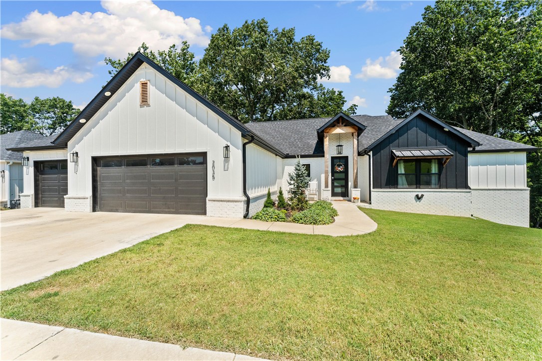 OPEN HOUSE THIS WEEKEND! Want to live on the golf course? Here’s your chance! This beautiful two-story home in Big Sugar Golf Course is near the clubhouse, driving range, and Big Sugar gravel trail. Just minutes from downtown Rogers and Bentonville as well as Bella Vista’s trail system. The primary and guest bedrooms are upstairs, while additional bedrooms sit in a spacious walkout basement with its own living area. A partially unfinished section—already counted in the square footage—could serve as a media room, gym, office or more. Only a couple years old, the home features updated systems, a solid roof, granite countertops, and luxury vinyl plank flooring throughout. Enjoy entertaining in the open floor plan, outdoor living on double decks, and ample storage in the three-car garage. So much to see. Book your private showing today!