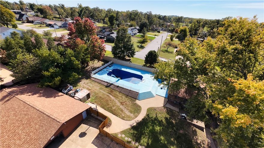 For families who want space, privacy, & easy access to Bentonville’s best outdoor amenities, this home delivers a lifestyle that’s hard to beat. Incredible location in Bentonville’s in-demand city limits, tucked in a well-established neighborhood where kids can safely ride bikes & play outside on a corner lot at the end of a quiet, family-friendly street. This split-level 3-bed, 2.5-bath home sits minutes from Downtown, Coler Mountain Bike Preserve, the Greenway, the square, coffee shops, trails, dog park, schools, & grocery stores. Includes: a fireplace, in-ground pool, detached garage, plus a 1,900-sf garage/workshop with electricity—ideal for hobbies, storage, or extra parking. Recent upstairs remodel (2024) added LVP flooring, new walls, fresh paint, crown molding, & modern fixtures. Whether your crew loves outdoor adventure or Bentonville’s exceptional amenities, this home delivers.