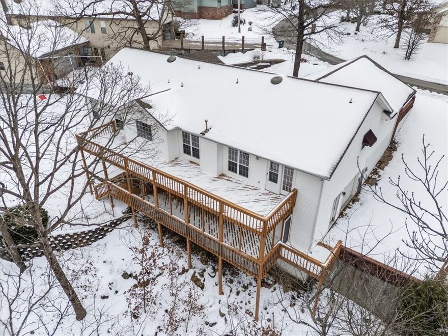 The more the merrier! This large and well maintained home is ready to welcome new owners. There is still time to cozy up this winter in front of a fire and enjoy your new home. A great layout and lots of privacy for the primary suite, a massive ensuite bath with jetted tub and a full size walk in closet.  Location is a key component to this homes opportunity and potential. Within one minute of the course, this home is centrally located with so much to offer. A large family or even a multi generational family would have ample room to spread out. The lower level could also easily become an income producing apartment. You could even separate the floors and have two long term or two short term rentals. This would make a lovely full time or part time lake area home. Lake Life...play golf in the morning and ski in the afternoon! Shopping center is just around the corner and the Holiday Island Marina is only about 2 miles away. Eureka Springs is about 10 minutes while Branson and Bentonville are both about an hours drive