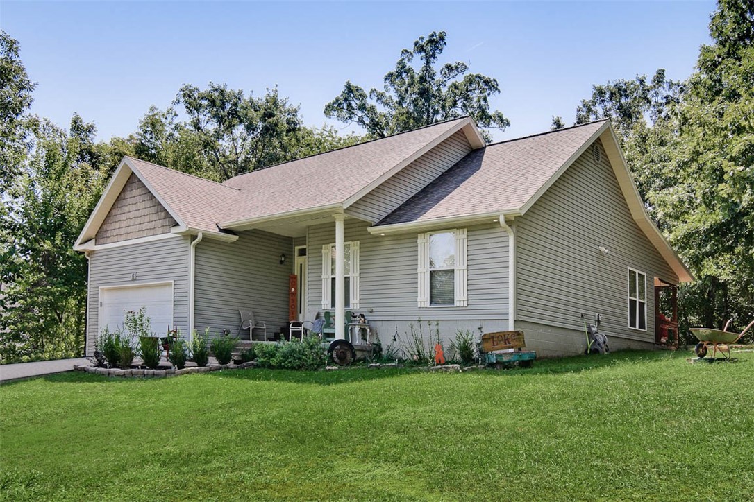 Welcome to this charming single-story home tucked in the Devonshire subdivision of Bella Vista, just minutes from Lake Windsor. This home has private office with French doors that is perfect for working from home. The interior is light and welcoming with wood-surface flooring, fresh paint, updated fixtures, and large windows that bring in plenty of natural light. The kitchen boasts granite countertops, while both bathrooms include dual vanities for added convenience. Step outside to a rare, flat backyard with mature trees and a covered tile patio, creating the perfect spot for relaxing or entertaining. Sitting on a 0.29-acre lot in the desirable Bentonville school district, this home also includes an attached two-car garage and easy access to Bella Vista’s lakes, trails, and amenities. Move-in ready with new carpet in bedrooms and well cared for, this property offers both comfort and a serene setting. This home is near the Tweety trailhead.