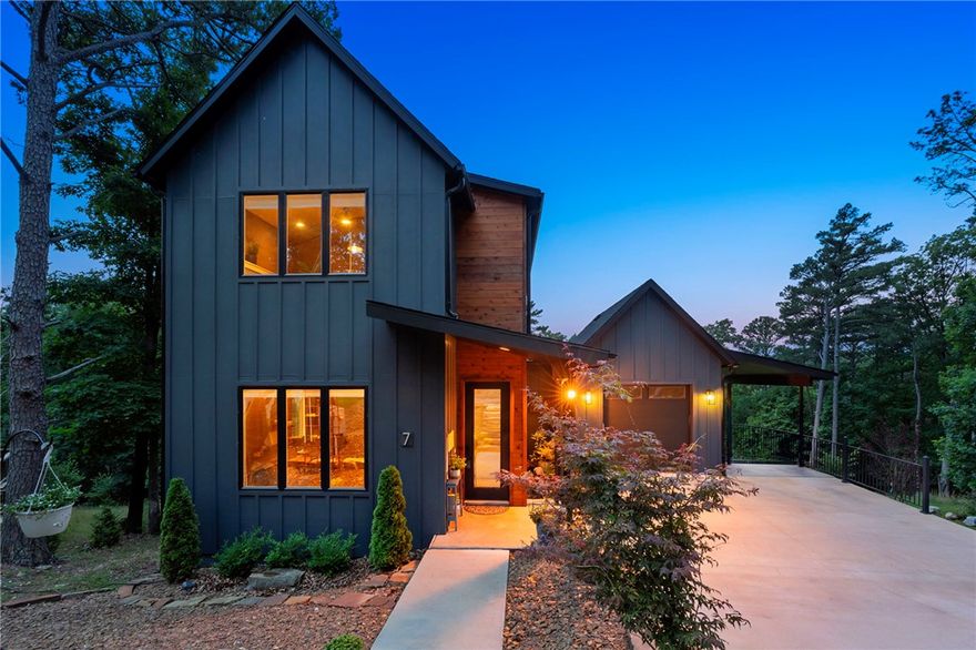 Modern 3BR/2BA home with open-concept living on .42 acres near trails, the lake, and the new Oz bike park lift. Thoughtfully designed with quartz countertops in the kitchen and baths, spacious living areas, a walk-in pantry, and loft office space ideal for remote work or guests. Enjoy two decks plus a peaceful sitting area overlooking green space, lawn, and mature trees. Downstairs bonus area not included in square footage offers flexible space for a workout room, hobby area, or additional storage. Contemporary finishes and functional layout make this home perfect for full-time living or a weekend retreat. Potential future AirBNB opportunity subject to permit availability.