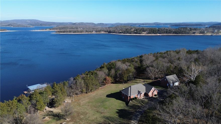 A rare opportunity on Beaver Lake in coveted Ventris Point, this custom-crafted home blends timeless design with thoughtful engineering. Set on over 3 acres in one of the lake’s most protected deep-water coves, the property offers privacy, durability, and exceptional lake access. Vaulted ceilings, granite counters, energy-efficient features, abundant storage create a home designed for comfort and function. Private dock features oversized 30x32 slips with lifts, two swim platforms, sea anchored—ideal for year-round enjoyment. Multiple garages (attached and detached) provide five total bays plus bonus rooms, perfect for hobbies, guests, or future expansion, also treehouse and another storage building by water. Recent improvements include new roofs, gutters, HVAC, generator, dock upgrades, and extensive system updates. Landscaped, wooded, and gated, with paved access and private utilities, this is a true legacy lake home—engineered to last, designed to live in, and positioned for unforgettable Beaver Lake living!