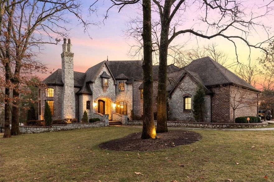 This beautiful home is nestled on .85 acres in the highly desirable East Fayetteville area. The exquisite residence is 5,401 sq. ft. with 5 bedrooms, 4.5 baths, rich with features for outdoor entertaining and convenient to everything! This home is within walking distance to Vandergriff Elementary, McNair Middle School, Gulley Park, Razorback Greenway, and close to shopping and dining. Exteriors include an inviting patio, a breezy back porch, and a wood-burning fire place with a built in kitchen. Inside you will find an impressive entryway, solid hardwood floors throughout, notable ceiling styles, and two gas fireplaces in the living room and den. Expansive chef's kitchen is lovely with attractive island layout, two ovens, and granite countertops. The attached three-car garage has two electric car chargers, a private heated/cooled recreational room and walk in storage under the house. Very rare .95 acre lot located next to home available to purchase with home. MLS #1241522