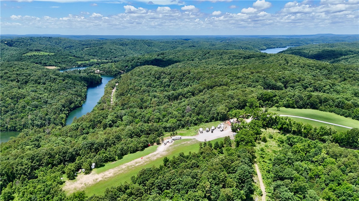 A lucrative investment property or expansive private homestead, this 48 acre, income- producing estate has limitless potential! It’s only minutes from Beaver Lake & just 13 minutes to Eureka Springs. The land features 7 RV sites w/ breathtaking panoramic views, 2 of which are premium sites w/raised garden beds and landscaping. Highlights include cleared fields & pastures, abundant wildlife, 10 historic barns, full hookups at all RV sites, including 20/30 & 50-amp power, sewer, and water + 500 gal. propane w/ generator + many mature oak, redwood, dogwood & walnut trees. The water source is a 600 ft well, producing crystal-clear clean water. The RV park currently generates over $30K in annual revenue via monthly & nightly rental w/ potential for exponential profit growth. There is plenty of land for expansion of the business & increased revenue, whether it be through building additional RV spots, tiny homes, or Airbnb space. Will subdivide. Don’t miss this rare opportunity to own a valuable piece of the Ozarks!
