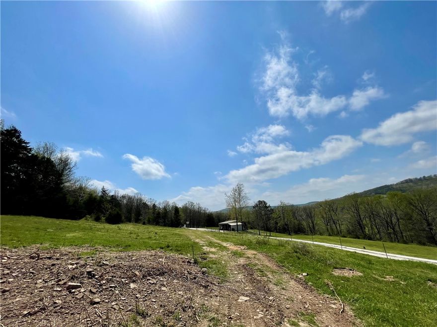 10.73 scenic acres featuring a wet weather creek, wooded terrain at the southern end, and open spaces with extended views NW. This property offers seclusion and privacy while being in close proximity to the amenities provided by Wesley, Elkins, Fayetteville, and Huntsville, AR. With additional fencing work, you can establish your own small farm with animals of your choice. The property boasts a beautifully renovated farmhouse with numerous updates, a renovated basement, and a studio apartment suitable for various purposes, including a personal business or guest accommodations. Additional features include a two-car garage adjacent to the studio apartment and covered parking near the basement. The studio apartment and garage building measures approximately 26x50, with an old chicken coop of 10x12 and a 24x30 lean-to structure at the southern end of the home for animal shelter. See MLS# 1305102