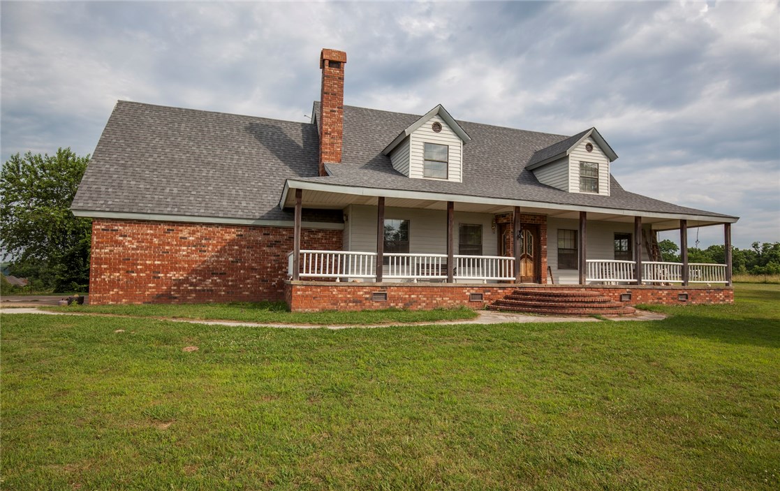 Charming home with a picture perfect front porch on 74 +/- acres in rural Benton County. Large master bedroom downstairs with en suite, and additional bedrooms are generous with space as well! Get a little piece of serenity near Osage creek and Hwy 412. Want more land with the home? This home is a part of 207+/- adjoined acres across multiple parcels that has been in the family for many years. Fencelines do not follow parcel lines, so offers requesting additional acreage would be entertained by seller.