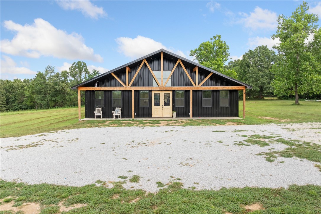 Sleek, modern, and move-in ready! This stunning black-on-black barndominium-style home is actually a custom stick-built masterpiece sitting on just over 22 gorgeous acres just north of Bergman. Built in 2024 with a fresh, modern aesthetic, the home offers 4 spacious bedrooms, 3 full bathrooms, and a showstopping great room with soaring ceilings and oversized windows that flood the space with natural light. You'll love the wide-open kitchen and dining area, the luxury finishes throughout, and the clean, contemporary vibe that sets this home apart. Outside, enjoy a long private drive, a peaceful country setting, and a 3-bay detached shop building, perfect for hobbies, storage, or business use. Located on a paved county road with land that lays beautifully, this property offers the best of both worlds: privacy and convenience, just minutes from Harrison.