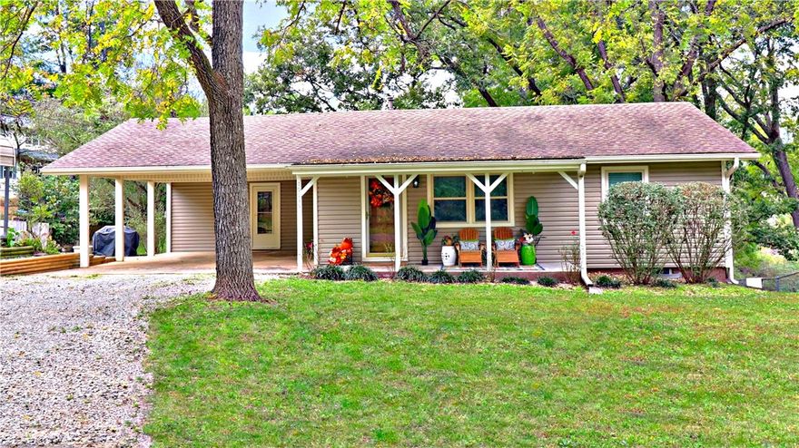 Move-in ready 3BR/2BA home in a peaceful lake community, conveniently located near Fayetteville and Springdale. The covered front porch, spacious back deck, and partial lake views create a welcoming setting, while fresh interior paint gives the home an updated feel. Just 1/4 mile from community lake access and a boat ramp, it’s perfect for enjoying time on the water. The main level features a living room, kitchen, two bedrooms, a full bath, a laundry/mudroom, and an office with built-in desk and cabinetry. The lower level, with exterior access, includes a second living area, a bonus room, a bedroom, a full bath, and an additional room that could serve as a 4th bedroom or flexible space to fit your needs. Additional property highlights include two carports, a 12x16 tool shed with power and lights, and an 11x26 boat storage carport with power and lights. This home is perfect for full-time living or as a weekend retreat. Seller is ready to review offers & can accommodate a quick close!