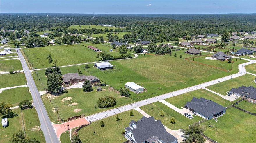 2.01 ACRES OF SPACE TO CALL YOUR OWN! This 3,719-square-foot home offers room to live, work, and create. Inside, two oversized bonus rooms flex easily as extra bedrooms, home offices, studios, or media spaces, designed to evolve with your lifestyle. The eat-in kitchen is made for real life, with plenty of room to cook, gather, and linger. Recent updates include a new roof. Step outside to a covered front porch perfect for slow mornings, and an iron-fenced backyard that provides privacy and a secure space for pets or play. A built-in security system adds peace of mind. And when you’re ready to go, you’re just 10 minutes from Walmart HQ, 4.7 miles from downtown Bentonville, and minutes from nearby parks and trail systems, ideal for biking, hiking, or a quick outdoor reset. Space, flexibility, and location - all in one home.