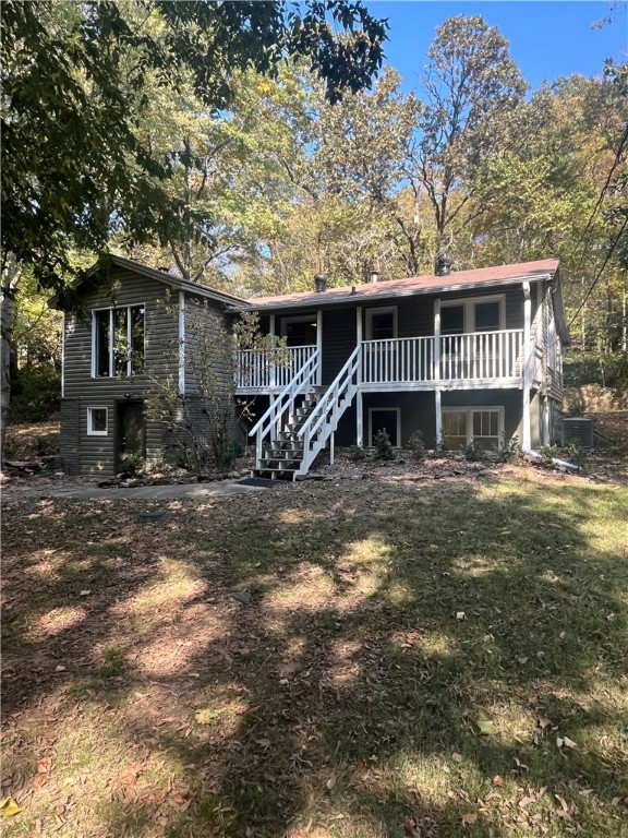 This beautiful 2 story home fully renovated, has 4 bedrooms, 2 full bathrooms and it sets on 1 acre, tucked away but visible from Hwy 71 with wooden bridge crossing and a seasonal creek. 1960's cottage with some wood floors, knotty pine lined walls and a native stone fireplace (no wood burning). It has vaulted ceiling in living room. It has french doors that open to outdoor concrete landing with pretty old stone wall and landscaping.