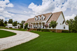 Beautiful Ranchette Country Home! The custom built home features 3 bed, 3.5 baths, hardwood floors, granite counters, office and formal dining room. The home has a security system, surround sound, a whole house humidifier, attic fan, newer roof and zoned heat/air. The crawl space is lighted and has a moisture barrier. Enjoy the country view while sitting on the covered front or back porch. There is a 48x30 barn with three horse stalls, workshop area and an air conditioned man cave. The property is well manicured & landscaped. The acreage is fenced for horses & can be purchased with either 5 or 10 acres.