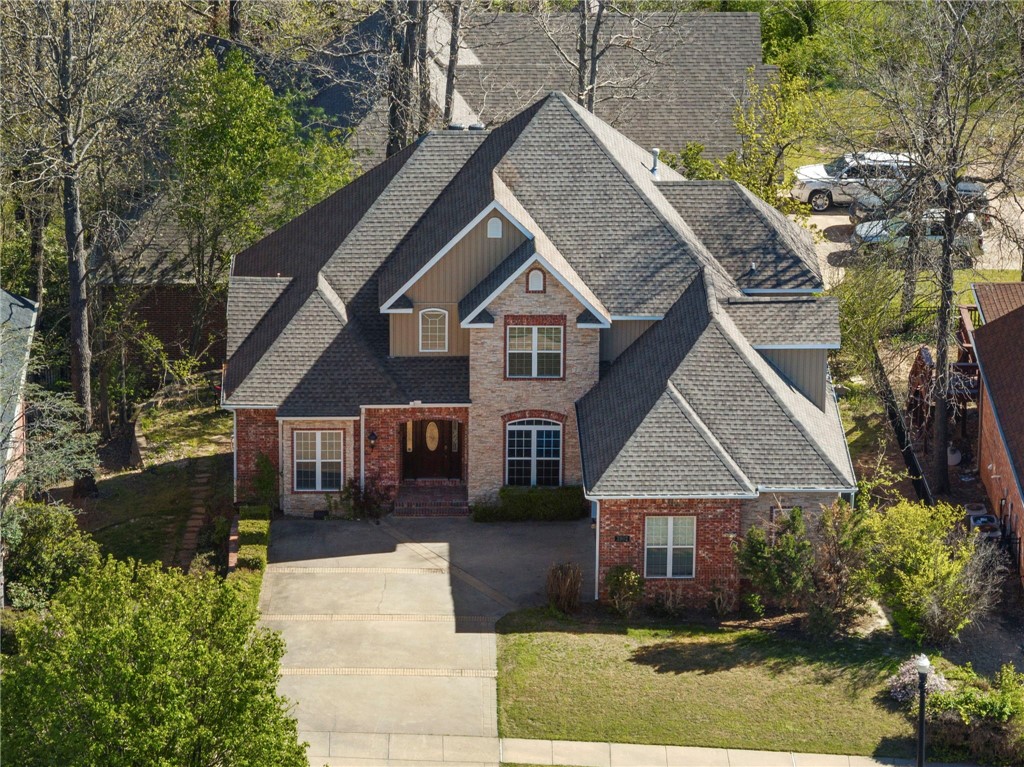 *Up to $3,500 preferred lender credit* Ideally located minutes from everything downtown Bentonville has to offer—Crystal Bridges, 8th Street Market, trails, & easy highway access—this beautiful home blends charm & functionality. Inside, the spacious kitchen features hardwood floors, granite countertops, & a cozy fireplace in the breakfast nook. Primary bath includes a clawfoot soaking tub, dual vanities, walk-in closet. The fully finished walk-out basement offers flexibility, complete with a large family room, kitchenette, bedroom, full bath, and office—perfect for a private guest suite or mother-in-law quarters. You’ll also appreciate extra storage under the stairs & a workshop with private entrance. Upstairs, 2 additional bedrooms, each with en-suite bathrooms, plus a versatile hobby room. Don't miss the expansive attic—ideal for finishing into a bonus room or additional storage. Raised deck perfect for entertaining, or relax on the covered patio below, easily accessed from the walkout basement. Roof 2024.