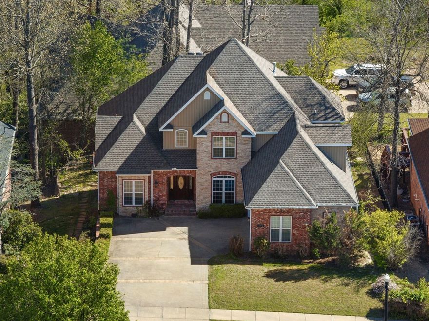 *Up to $3,500 preferred lender credit* Ideally located minutes from everything downtown Bentonville has to offer—Crystal Bridges, 8th Street Market, trails, & easy highway access—this beautiful home blends charm & functionality. Inside, the spacious kitchen features hardwood floors, granite countertops, & a cozy fireplace in the breakfast nook. Primary bath includes a clawfoot soaking tub, dual vanities, walk-in closet. The fully finished walk-out basement offers flexibility, complete with a large family room, kitchenette, bedroom, full bath, and office—perfect for a private guest suite or mother-in-law quarters. You’ll also appreciate extra storage under the stairs & a workshop with private entrance. Upstairs, 2 additional bedrooms, each with en-suite bathrooms, plus a versatile hobby room. Don't miss the expansive attic—ideal for finishing into a bonus room or additional storage. Raised deck perfect for entertaining, or relax on the covered patio below, easily accessed from the walkout basement. Roof 2024.