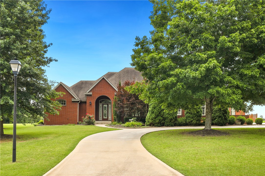 This stunning estate is located in the highly sought-after Vineyards, on 2.16-acre lot, convenient to everything in Fayetteville. As you enter the home you will find the elegant design & high-end finishes throughout. The spacious living areas feature soaring ceilings, beautiful hardwood floors, lots of natural light, and a stunning fireplace with built-in shelves. Your gourmet kitchen is sure to impress, custom cabinetry, and ample counter space for meal prep and entertaining. The adjacent nook is perfect for having quaint dinners and if you are having a large social event you can host your guest in the formal dining connected to the living area. The primary bedroom features a vaulted tray ceiling, & a private door to the back patio. After a long day enjoy your spa-like primary bathroom and jacuzzi tub. Outside you find a beautifully landscaped yard, perfect for hosting outdoor gatherings or enjoying the serene surroundings.