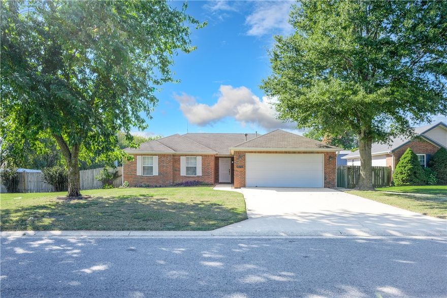 Welcome to 1005 Zachary Street, where comfort and convenience come together in the heart of Centerton. This charming 3-bedroom, 2-bath home offers 1,302 square feet of inviting living space on a beautifully level 0.24-acre lot. Step inside to a bright, open layout with vaulted ceilings that create a spacious yet cozy feel — perfect for relaxing evenings or gathering with friends. The eat-in kitchen is warm and functional, featuring plenty of cabinetry and natural light that makes mornings feel a little brighter. The primary suite offers a peaceful retreat with dual closets and a private bath, while two additional bedrooms provide flexibility for guests, an office, or a hobby room. Outside, enjoy a fenced backyard with an open patio — ideal for grilling, gardening, or just soaking in a quiet Arkansas sunset. With its prime location near schools, parks, and shopping, this home delivers small-town charm with modern convenience — ready to welcome you home.