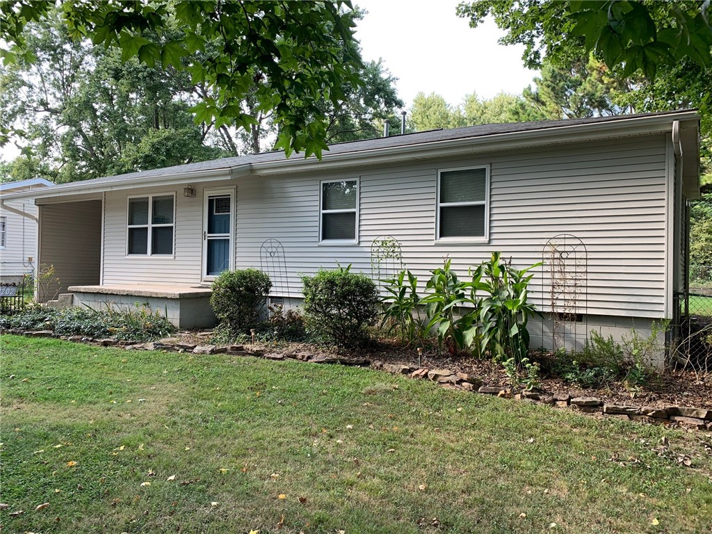 Great starter 3 bed / 1 bath home on tree covered, landscaped lot with laminate flooring throughout. Siding and roof less than 5 years old. Upgraded kitchen cabinets with roll-out shelves. Backyard deck is made from weatherproof encapsulated wood. Big 20 x 20 storage/workshop barn built approx on concrete slab has 2 levels (with stairs for access) and overhead door. Pop up sprinkler system for trees and garden area.