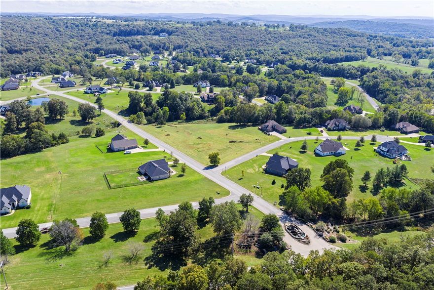 Discover the perfect setting for your new home with this prime 2.27-acre lot in The Knolls Subdivision. Located on Fayetteville's beautiful East Side, this desirable property offers the best of both worlds: a spacious, open canvas for construction and incredible lifestyle amenities. Residents enjoy a pool, four new pickleball courts, a tennis court, a clubhouse, and miles of walking trails. All essential utilities are available at the street, including public water, natural gas, underground electricity, and high-speed internet. Plus, you’re just a short 10–15 minute commute to Fayetteville and the University of Arkansas. Zoned for Vandergriff Elementary and McNair Middle School, don't miss out on this opportunity in a highly sought-after neighborhood!