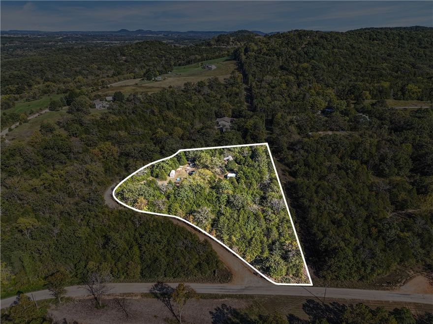 +/- 3.5 acres of wooded land available outside Eureka Springs, AR, offering the perfect setting to build your dream home, surrounded by trees for complete privacy. Located in the beautiful Hills of Keels Creek subdivision, this property provides a peaceful, natural backdrop while still being close to town. The property borders the OMS sanctuary and has lots of mature trees. Electric service is available at the street, and the sellers have already secured a septic permit for a three-bedroom home, making the building process even easier. A water well and septic system will be needed. 5 buildings to convey: 10x20 with porch partially finished interior, 14x32 partially finished interior, 12x32 shell, 10x20 partially finished interior, and a 20x20 pole barn. Situated about 3.5 miles from Highway 62 and 6.5 miles from Downtown Eureka Springs, this property combines the tranquility of the woods with easy access to all the charm and amenities of Eureka Springs.