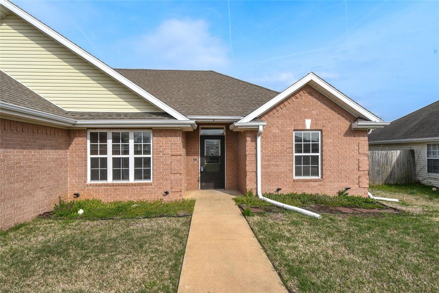 This home has been thoughtfully updated with fresh paint throughout (excluding the kitchen), new light fixtures, and ceiling fans. The west-facing windows are tinted for energy efficiency, and the bathrooms features new shower heads and hardware. The kitchen is equipped with a refrigerator (2019), a new stove, microwave, and dishwasher (2023), and a brand-new garbage disposal (July 2024). The water heater was replaced in 2015. Additional improvements include an insulated garage door (August 2023), a new garage door opener, a new attic door, and a master bathroom exhaust fan with Bluetooth capability. Conveniently located near John Brown University, the Family Aquatic Center, downtown Siloam Springs, Memorial Park, and just a 10-minute drive to the Oklahoma border, this property offers both modern amenities and a prime location.