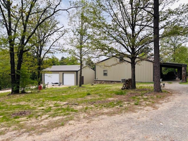 Charming 3-bedroom, 2-bath steel-framed home nestled on nearly 4 partially wooded, unrestricted acres at the end of a quiet dead-end road—just minutes from Clinton!
This unique property features an open layout with a large kitchen, a split-bedroom design, and oversized bedrooms, each with its own private exterior door. Both bathrooms are spacious and well-appointed. The home and detached 3-car garage are both built with durable steel framing for added strength and longevity. Step out onto the back deck and enjoy peaceful views of the yard, a meandering creek, and even a couple of neat rock formations on the property! Upstairs, the unfinished attic with a half-bath offers incredible potential for additional living space. With privacy, natural beauty, and convenience to Greers Ferry Lake (less than 10 minutes away!), this home is a rare find full of opportunity. No restrictions—bring your vision!