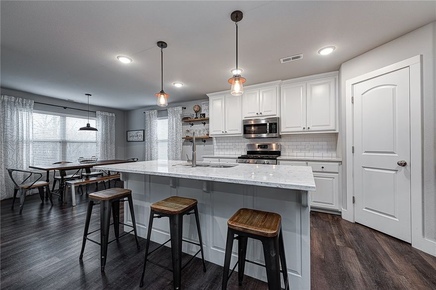 You'll fall in love with this like-new 3 bed, 2 bath home with modern farmhouse styling and tons of unique touches. Enjoy private, panoramic views in the beautiful hills of Cave Springs all while being minutes from downtown Bentonville. This home is one of a kind with custom features such as two barn doors in the entryway and master bedroom, custom fireplace design with subway tiles and wood mantle, rainfall shower head in the master bath as well as beautiful vinyl plank floors throughout the home. Entertain guests in the kitchen, complete with large, quartz-top island, subway tile back-splash and white cabinetry or host outside under the large covered back deck. Situated in Cave Springs, owners will be within the Bentonville School District.