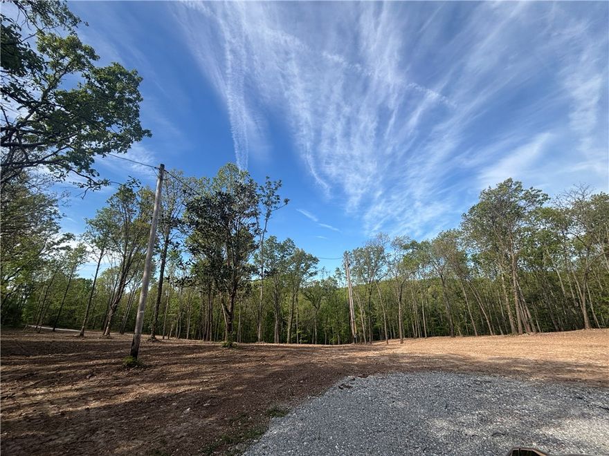 With open terrain and scenic surroundings, the possibilities are endless! Build your dream home on this 2.565 acre manicured piece of paradise or simply invest in one of the fastest-growing regions in the state. Discover the perfect blend of country tranquility and city convenience with dining, shopping, schools, and entertainment nearby. Don’t miss this rare opportunity to own acreage in a prime location just minutes from the heart of Bentonville! This cleared & graded gem is zoned for Bentonville School District and offers quick access to The Back 40 Loop! City water & electric are at the street. Survey reflects 2.565+/- acres, see survey in supplements. Also listed ML #: 1343639 & 1343640. Property boundary lines in photos are approximate and are for reference only.