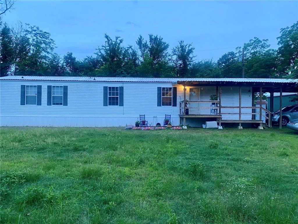 Built in 2007, this 2-bedroom, 2-bath home sits on a peaceful 0.64-acre lot just minutes from Blue Mountain Lake and public hunting land. Mount Magazine can be seen from the road and even from the front porch—offering a beautiful view in every season. The home offers a simple, functional layout with two full bathrooms and plenty of cabinet space. A few flower beds have been started, but with this much yard, there’s room to create a garden, outdoor hangout, or just enjoy the open space. Whether you're looking for a weekend escape, a hunting or fishing retreat, a rental property, or a place to slow down and live the quiet country life—this one offers all of that and more. More pictures to come!