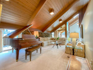 RARE OPPORTUNITY to own a beautiful mini-farm in the Ozarks just minutes from Harrison. This custom built home with incredible views is being offered on a private 14 acre parcel with a beautiful pond. It comes with a 32 x 50 metal utility barn with concrete floors, pull-through overhead doors and a 30 x 11 covered side shed.The home contains soaring ceilings and oversized windows give almost every room in the house a beautiful view of the surrounding acreage. Built in a Frank Lloyd Wright style with redwood paneling, large beams and natural stone floors; the home's architectural design offers an openness that blends with its natural setting. The home has a stunning two-story rock f/p adding the ambiance of a wood burning fire to both the study downstairs and the master bedroom.