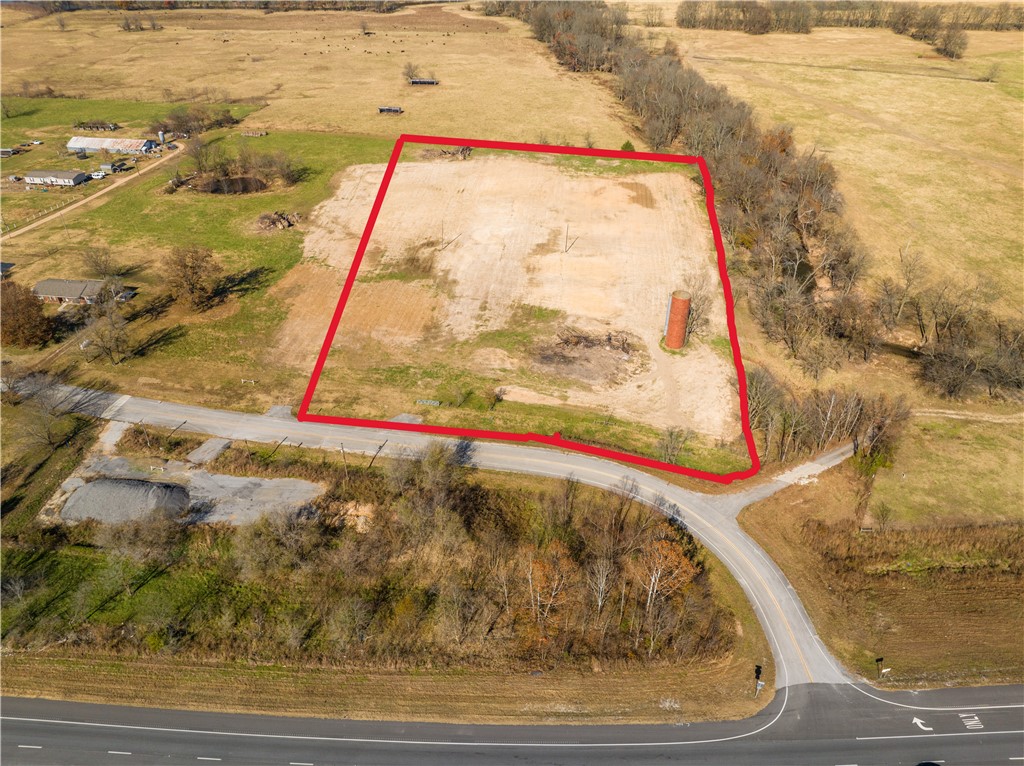 Cleared and ready for development! Build your business here conveniently located between Siloam Springs and Tontitown with Hwy 412 West intersection for convenience to go either direction! Build your home and business at same location! Beautiful old red silo on property offers unique opportunity for signage and location recognition! Electric at street. Requires a well and septic. No natural gas available. Exact acreage subject to new survey. 5 Miles to Siloam, 6 1/2 Miles to new 612 Interchange on 412, and 13 miles to I49/412 interchange! Unlimited possibilities! Taxes to be determined by survey/split. The very NE corner of the property is the only portion of the property in the flood plain.