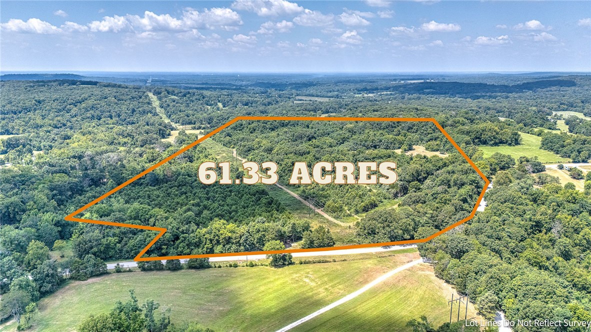Endless Possibilities Await on 61.33 Acres! Discover the perfect blend of natural beauty and functional land use with this gently rolling, highly usable acreage just minutes from Beaver Lake. This property is the perfect mix of open pasture and mature timber offering incredible versatility that is ideal for farming, cattle, recreation, or building your dream estate. Three ponds add scenic charm and provide water for livestock or wildlife. Several sheds and large shop/barn and multiple potential home sites give you the flexibility to build now or later or simply use the existing home site equipped with power, septic, and a private well. Whether you're seeking a private retreat, working land, or investment opportunity, this one checks all the boxes.