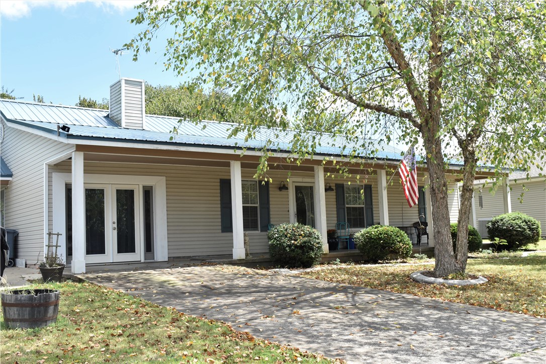 Imagine sitting on your porch watching the sunset over the lake. Nice home with some lake views. Boat launches within five minutes. This is two lots. Privacy fenced yard with above-ground pool. New roof in 2019, greenhouse, shop. Could have two bonus rooms also two living rooms. Has sunroom. 1 detached garage and workshop, and 1 attached carport.