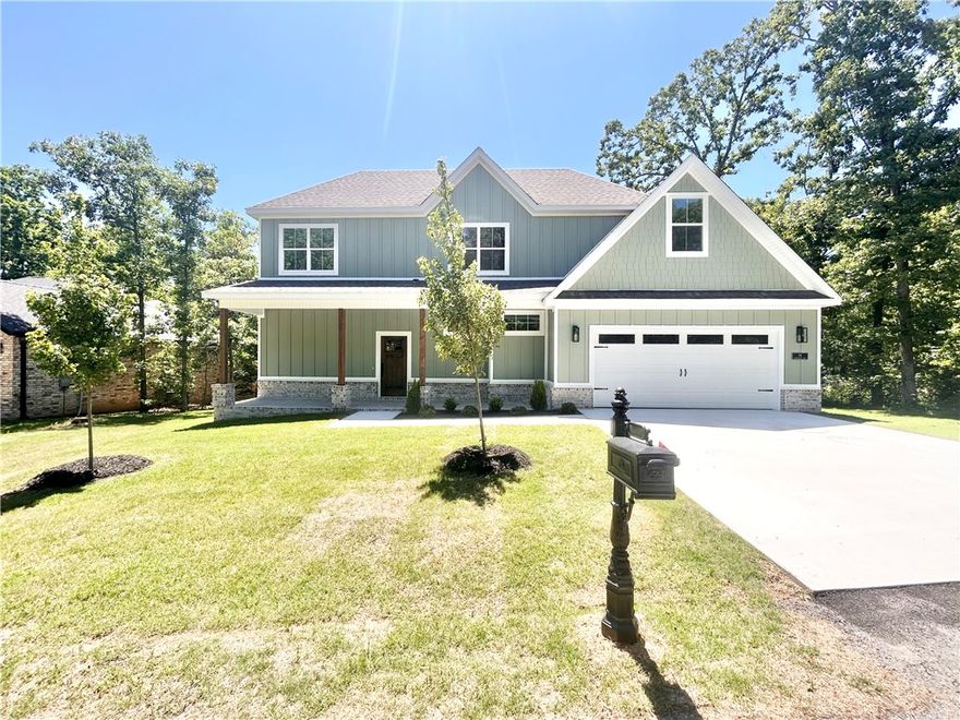 MOVE-IN READY! New construction with bonus room on a flat wooded lot near Lake Loch Lomond, Highlands Golf Course, Branchwood Recreation Center, and easy access to I-49. Step inside to discover a beautiful fireplace, custom cabinets, gas range, waterfall island, and elegant 3 cm quartz countertops. This thoughtfully designed home features 3 spacious bedrooms plus a versatile bonus room, providing ample space for entertainment. The primary bedroom is conveniently located on the main level. Bentonville schools! As an added bonus, this home includes $3,500 in buyer's closing costs when using the builder’s preferred lender!
