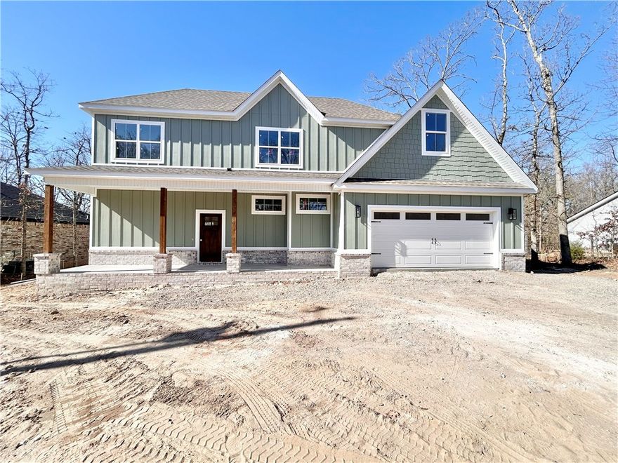 New construction with bonus room on a flat wooded lot near Lake Loch Lomond, Highlands Golf Course, Branchwood Recreation Center, and easy access to I-49. Step inside to discover a beautiful fireplace, custom cabinets, gas range, waterfall island, and elegant 3 cm quartz countertops. This thoughtfully designed home features 3 spacious bedrooms plus a versatile bonus room, providing ample space for entertainment. The primary bedroom is conveniently located on the main level. Bentonville schools! As an added bonus, this home includes $3,500 in buyer's closing costs when using the builder’s preferred lender!