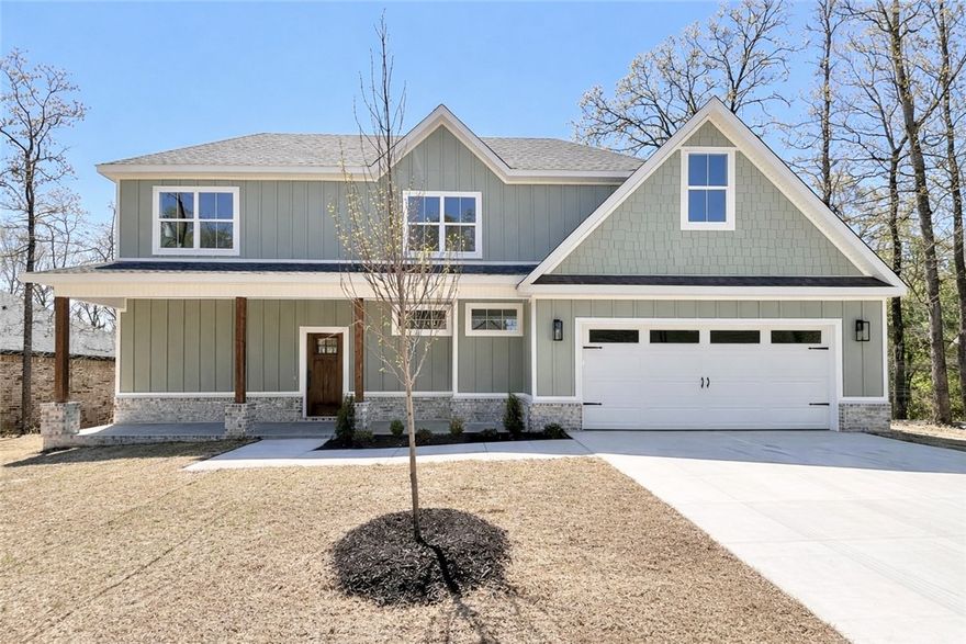 MOVE-IN READY! New construction with bonus room on a flat wooded lot near Lake Loch Lomond, Highlands Golf Course, Branchwood Recreation Center, and easy access to I-49. Step inside to discover a beautiful fireplace, custom cabinets, gas range, waterfall island, and elegant 3 cm quartz countertops. This thoughtfully designed home features 3 spacious bedrooms plus a versatile bonus room, providing ample space for entertainment. The primary bedroom is conveniently located on the main level. Bentonville schools! As an added bonus, this home includes $3,500 in buyer's closing costs when using the builder’s preferred lender!