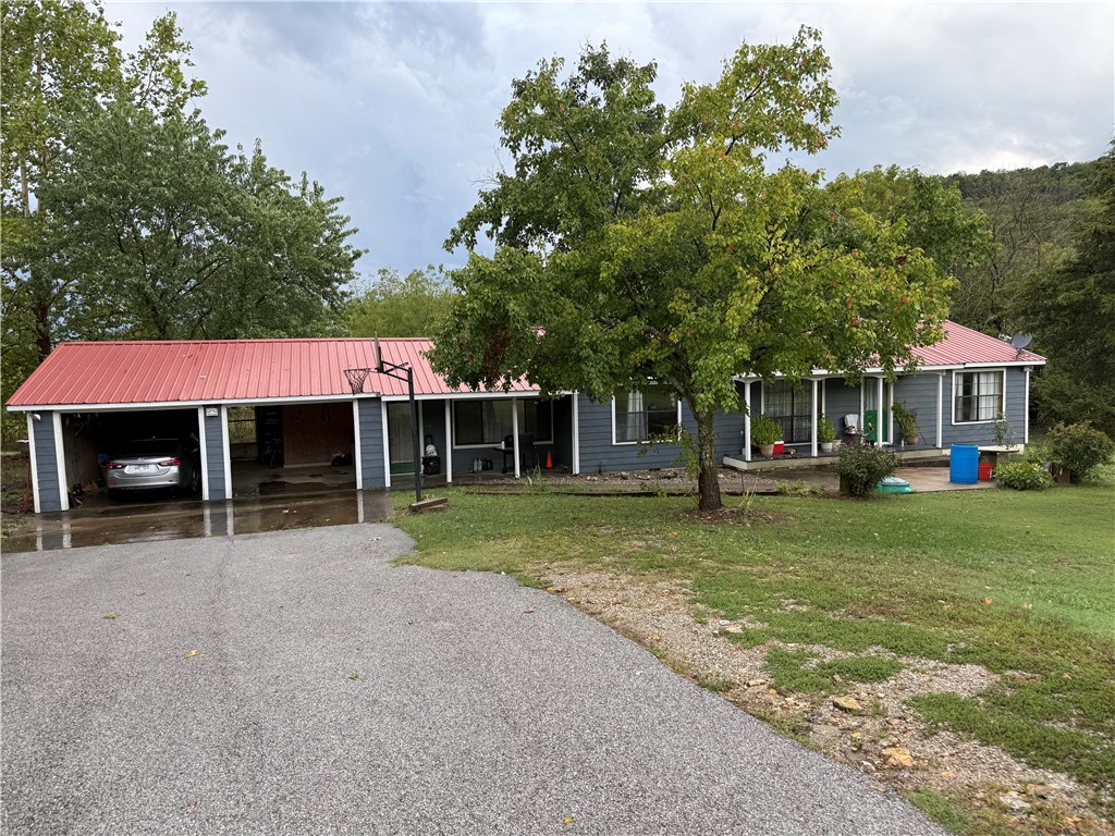 Spacious 3 bedroom 2 bath home located just off highway 62 close to Berryville and Green Forest, large yard almost a full acre, home has nice dining area and huge living room split floor plan. new deck, nice metal roof, large two car garage with work bench.