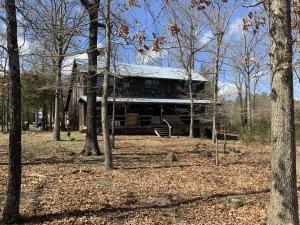Well built 3 bedroom 2 bath 2400 ft2 cabin/home on 10 mostly wooded acres with end of the road privacy. Only 1 mile off of State Hwy. 23. Open floor plan, walk in pantry, home is wired for all home generator. Well, 8ftx48ft covered porches on the front and back. Water softener, propane heat with wood backup. Lots of accessible storage off of the second floor. One bedroom and bath downstairs and two bedrooms and bath with office space/bonus room upstairs.