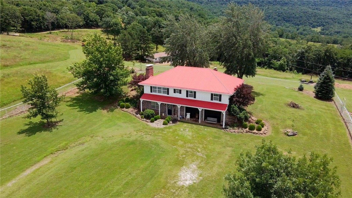 Incredible opportunity to own 150.33 acres of pristine Ozark beauty with some of the most phenomenal views in Newton County. This property offers a rare combination of featuresābreathtaking vistas, an abundant natural spring that flows from the mountain, multiple ponds, and meticulously maintained hay fields and pasture. The two-level main home offers 1,960 sq ft of living space with two separate living areas and a stunning fireplace. The driveway and landscaping add to the charm and comfort of the homesite. Additional structures include three older buildings with potential for renovation into guest homes or short-term rentals. A portion of the acreage is wooded and accessible from CR 4810, providing added privacy and flexibility. The wooded area extends above the bluff and offers a spectacular potential cabin site with top-of-the-world views. Whether you're looking for a private retreat, homestead, or investment opportunity, this property is unmatched in natural beauty and potential.
