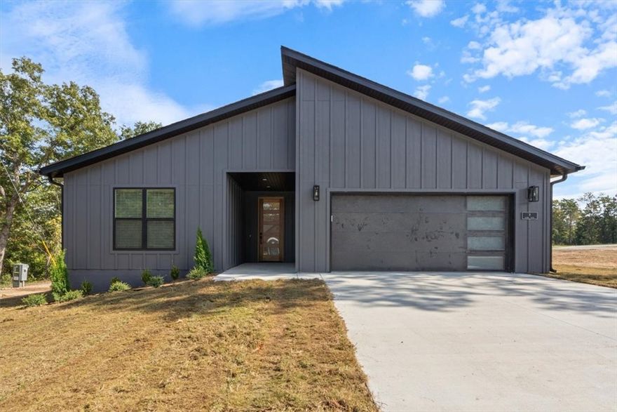 Professional photos coming soon! COMPLETION DATE OF 10/17. Modern new construction home on a flat .45-acre wooded corner lot. Close to Loch Lomond & Highlands Golf Course and less than 20 minutes from downtown Bentonville! This stunning residence features 3 beds, 2 baths, a waterfall kitchen island, premium black stainless steel appliances including a gas range, 3 cm quartz countertops, a walk-in pantry, custom cabinets, & high-end finishes throughout. The inviting living space boasts 10-foot ceilings and a beautiful fireplace, while the oversized custom tile shower adds a touch of luxury to the primary bath. Step outside to the large covered porch perfect for relaxation and entertaining. This is one you won't want to miss!