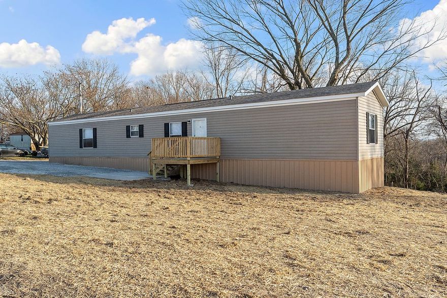 Check out this affordable home in excellent condition! Sits on almost 1 acre lot in area of nice homes and farms! Permanent foundation, Brand new roof, septic, deck, and move in ready! Storage building does not convey