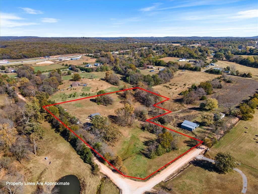 Beautiful property and home just 11 minutes to Rogers. Built in 2019 on 7.61 fenced acres with running springs, Onsite are two 50 AMP RV hookups. Home features 960SF open floor plan with 9 ft. ceilings, tons of storage, beautiful native stone and quartz countertops A mudroom with pantry unit and pull out shelving. The kitchen cabinets run floor to ceiling with no shortage on storage space. Living room is open to kitchen. Sliding glass doors in LR overlooks the backside of the acreage. Composite decking wraps around three sides of the house and will provide beautiful sunrise and sunset views. The large bedroom features a walk-in closet you will not believe. Thereās a garage, a large storage shed and a three sided pole barn to take care of all the outside storage needs. The acreage allows room to build additional home. Room for the boat, the camper, the horses or whatever you need to store. Enjoy biking or hiking at the National Military Park or drop the boat in nearby Beaver Lake just down the road.