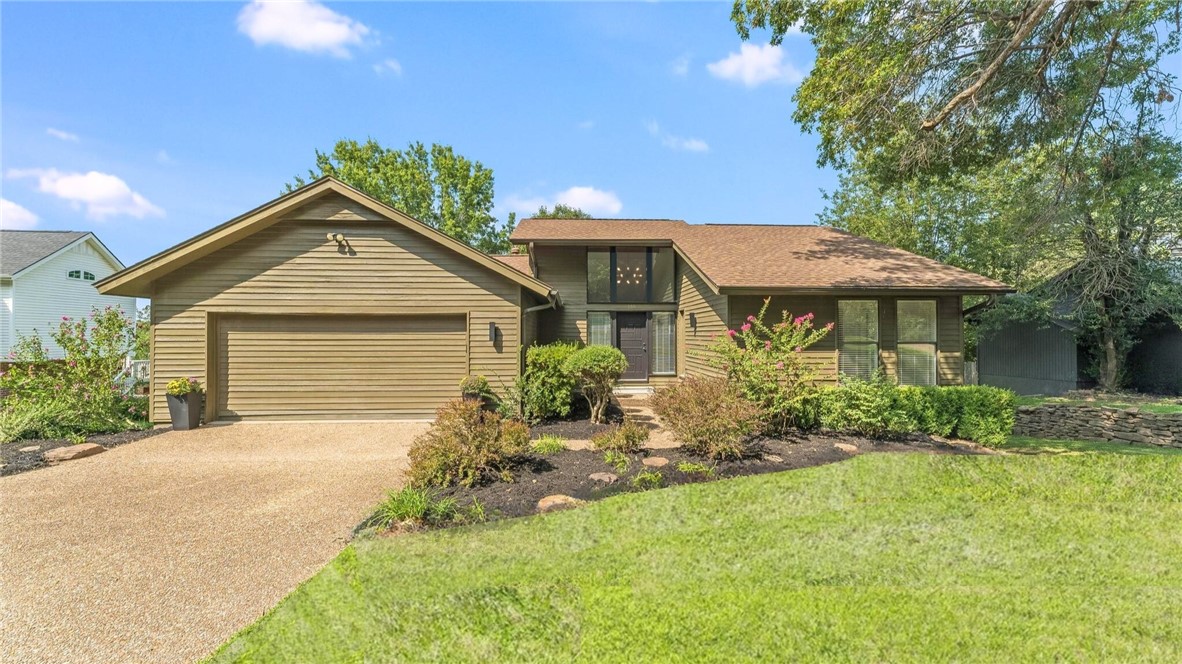 Welcome to Lake Road where lifestyle and location meet on the coveted border of Fayetteville and Springdale. Steps from Lake Fayetteville, this home connects you to trails, fishing, boating, and the 40 mile Razorback Greenway. The Botanical Garden and the Country Club are close, and the U of A, I 49, and Don Tyson Pkwy place shopping and dining within minutes. Inside, nearly 2800 sq ft include 4 beds and 3 baths with two on each level and a generous bonus living area downstairs that expands the way you live and entertain. Vaulted ceilings and oversized windows draw in natural light, while the home sits back from the street behind mature trees for a private feel. A large backyard and expansive multi level deck carry the living outdoors for easy gatherings and quiet evenings. Recent updates include a new water heater, granite counters, dishwasher, fresh paint, and MORE ; see full list and specifics attached. Don't wait! This is a rare chance to claim privacy and proximity in one of NWA’s most desirable settings.