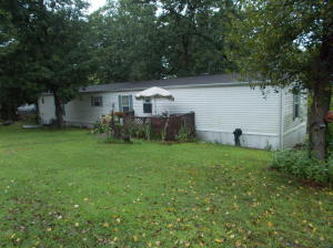 This is a beautiful 3 BR, 2 BA, mobile home on 37.49 Acres M/L with a 40 x 60 Metal Shop Building plus an older log home on the property with paved road frontage. The pond is full of Koia and gold fish and there is also a YEAR ROUND SPRING on the back side of the property. Lots of Deer and Turkey and even has a hunting camp on it.