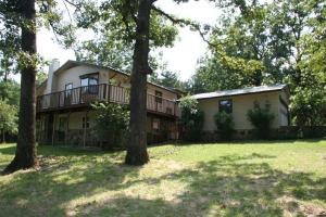 Tucked away on almost 6 acres this beautiful 4bed 2bath home has attractive cathedral ceilings,open floorplan,large windows for great natural light,walkout basement,wraparound deck,tankless hotwater heater,workshop and so much more!Come enjoy this park like setting with abundant wildlife and wet weather stream!
