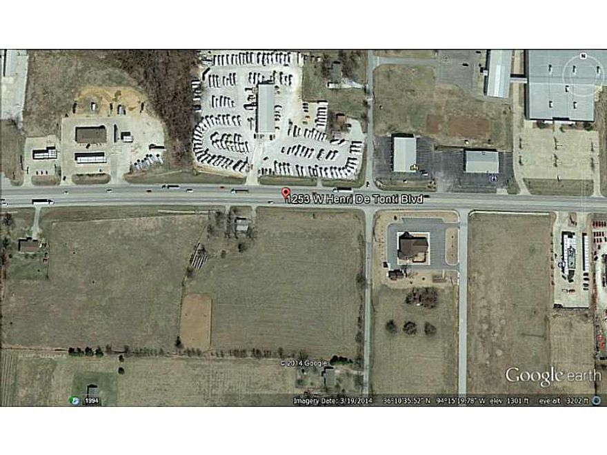 Great Commercial tract of 7.73 Acres on Busy Hwy 412 , Just 3 miles West of I-49. Open and level, East to development. Perfect site for your business.
