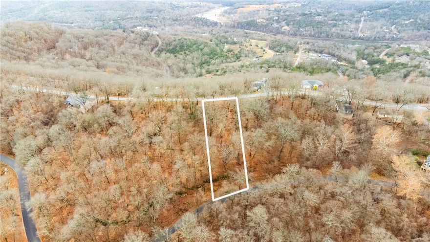 This lot is ideal for building your dream home on the main road. It reaches Hawk Drive and has stunning outcroppings and huge boulders on the back side. It is close to pool, clubhouse, utilities on site. This is a wooded lot with a beautiful mountain view and a reasonable price.